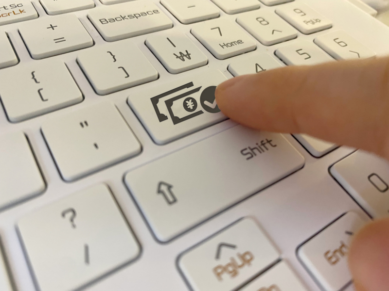 パソコンのキーボードでネット送金を行っているイメージ